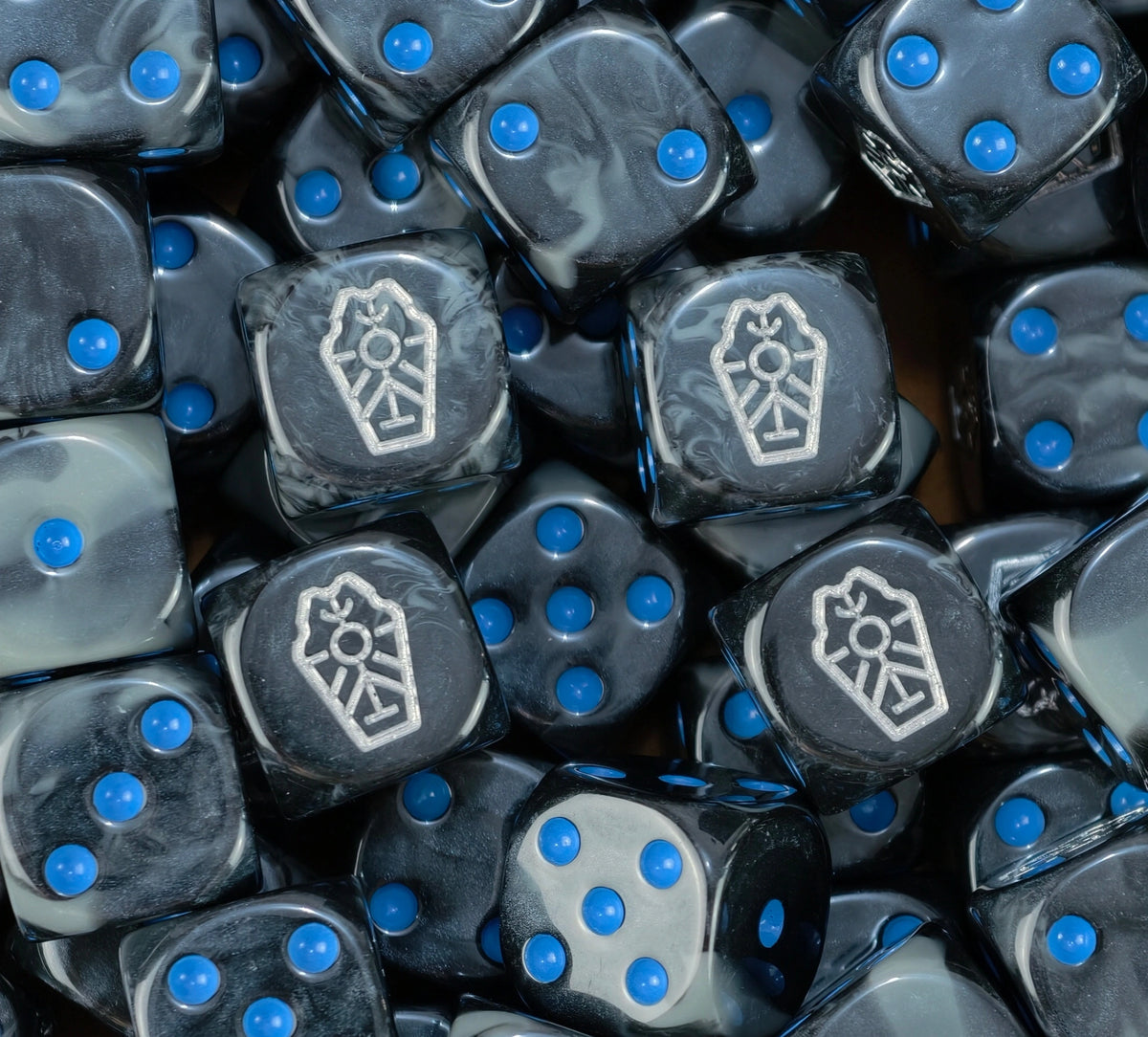 Pile of undying legion Necron dice in black and grey with silver glyphs and blue pips