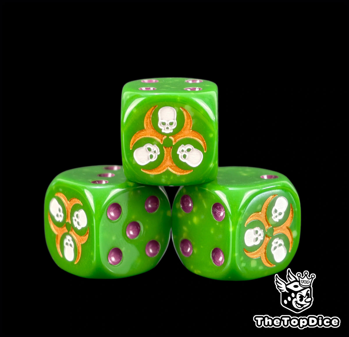 Three yellow flecked green plague dice with a gold three skull ring