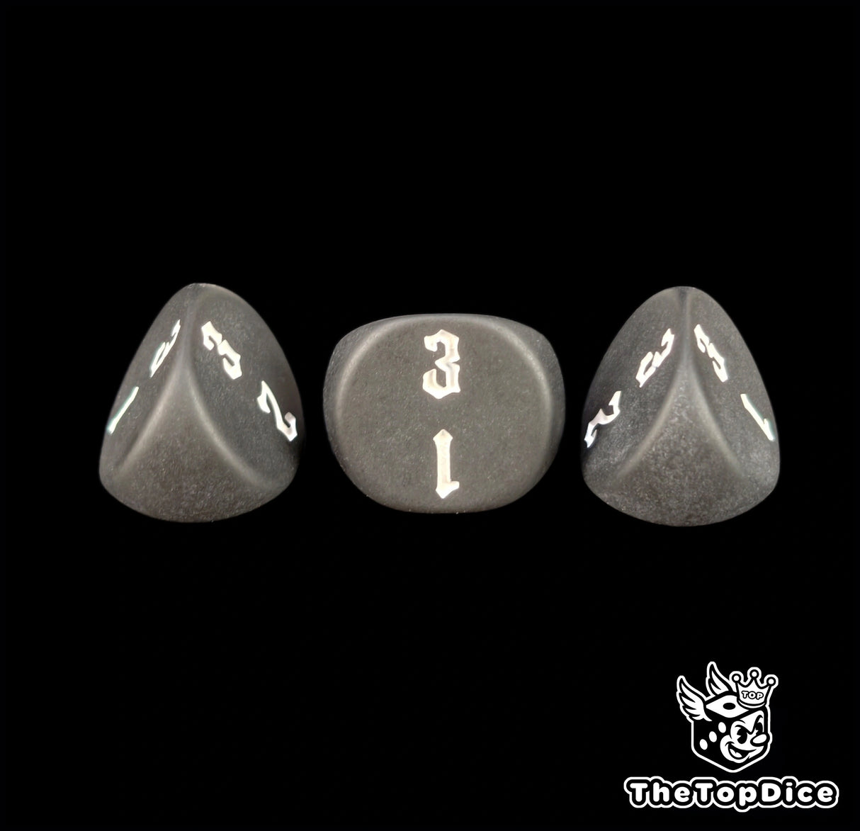Sharp engraving on matte black 16mm three sided dice, seen close