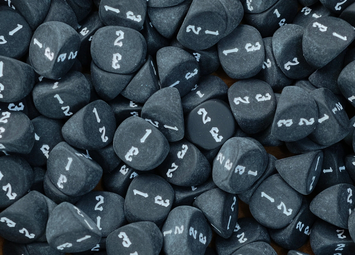 Black D3 dice loaded into a tray with the white numbering face up