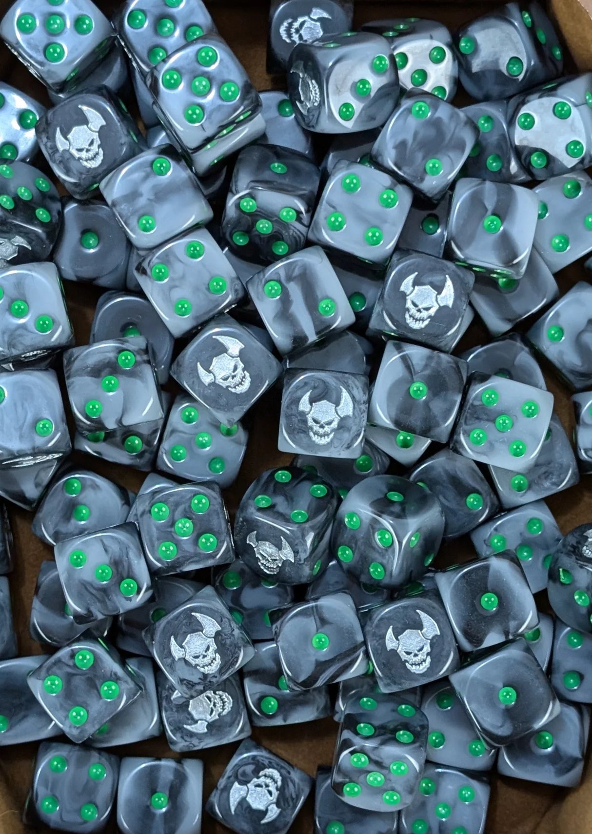 Pile of black orc 16mm D6 dice with green pips for a fantasy orc army