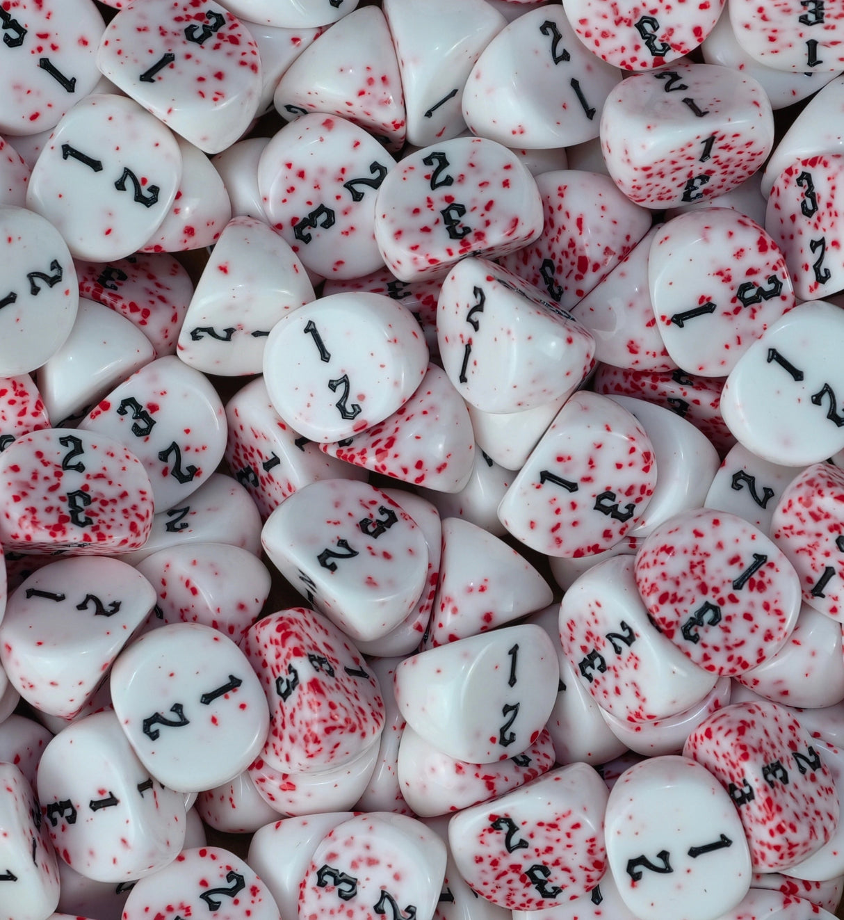 Bloodspatter three sided dice packed across a tray as wound markers