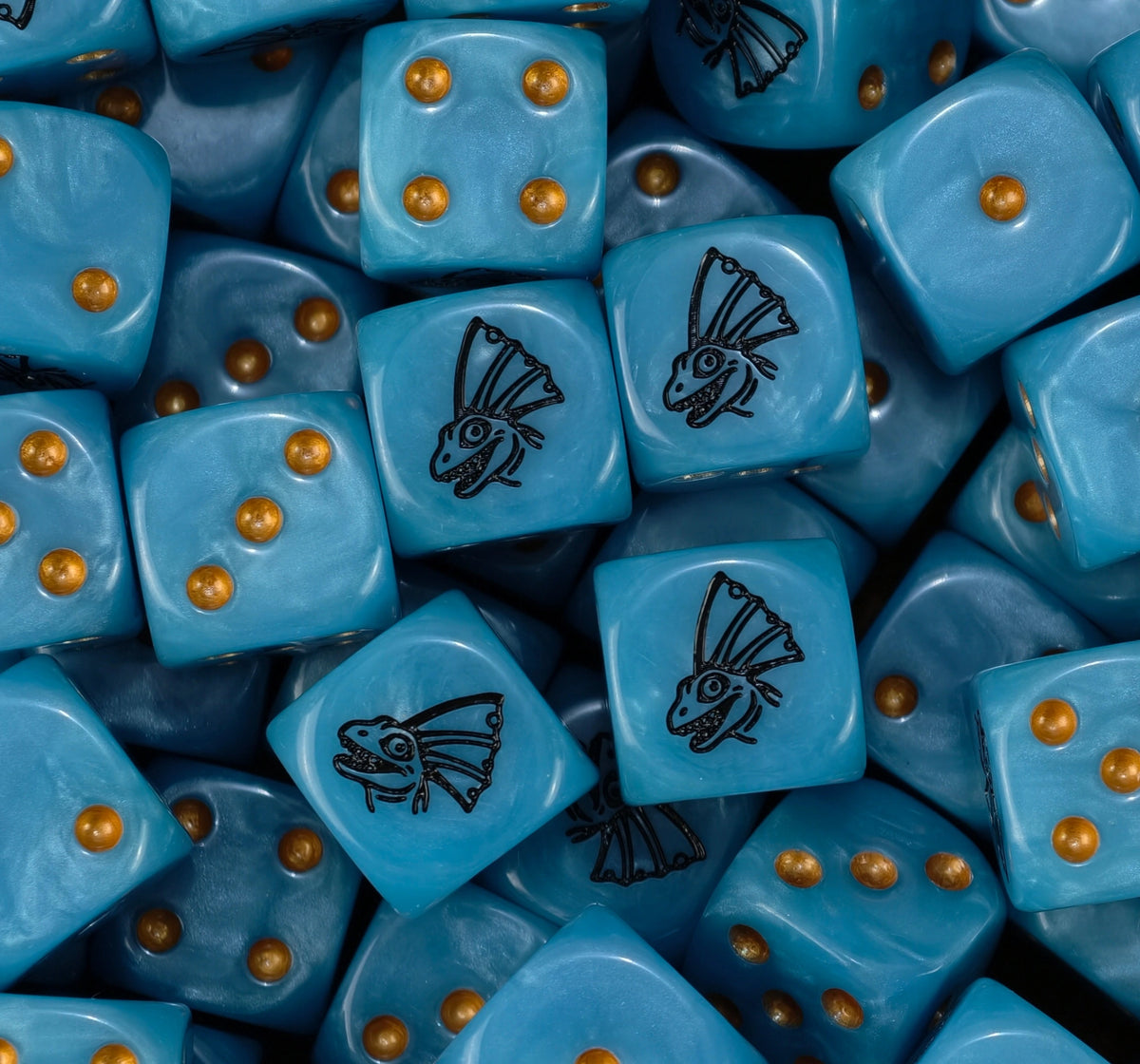 A pile of sky blue Seraphon dice with gold pips and black saurian masks