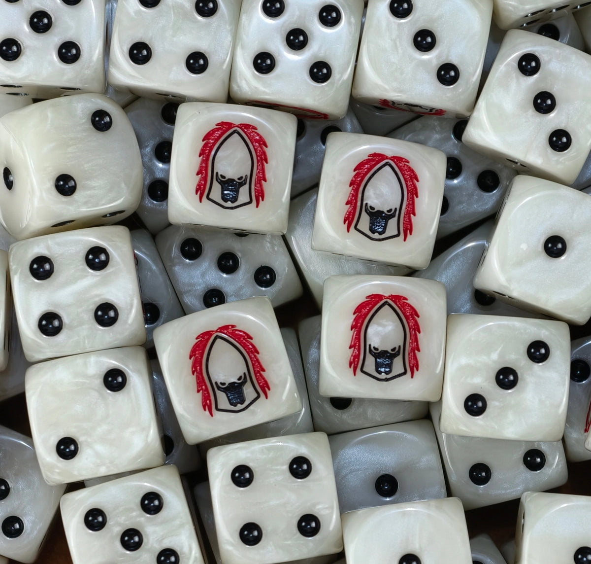 A pile of bone Howling Banshees dice with black pips and masked helms