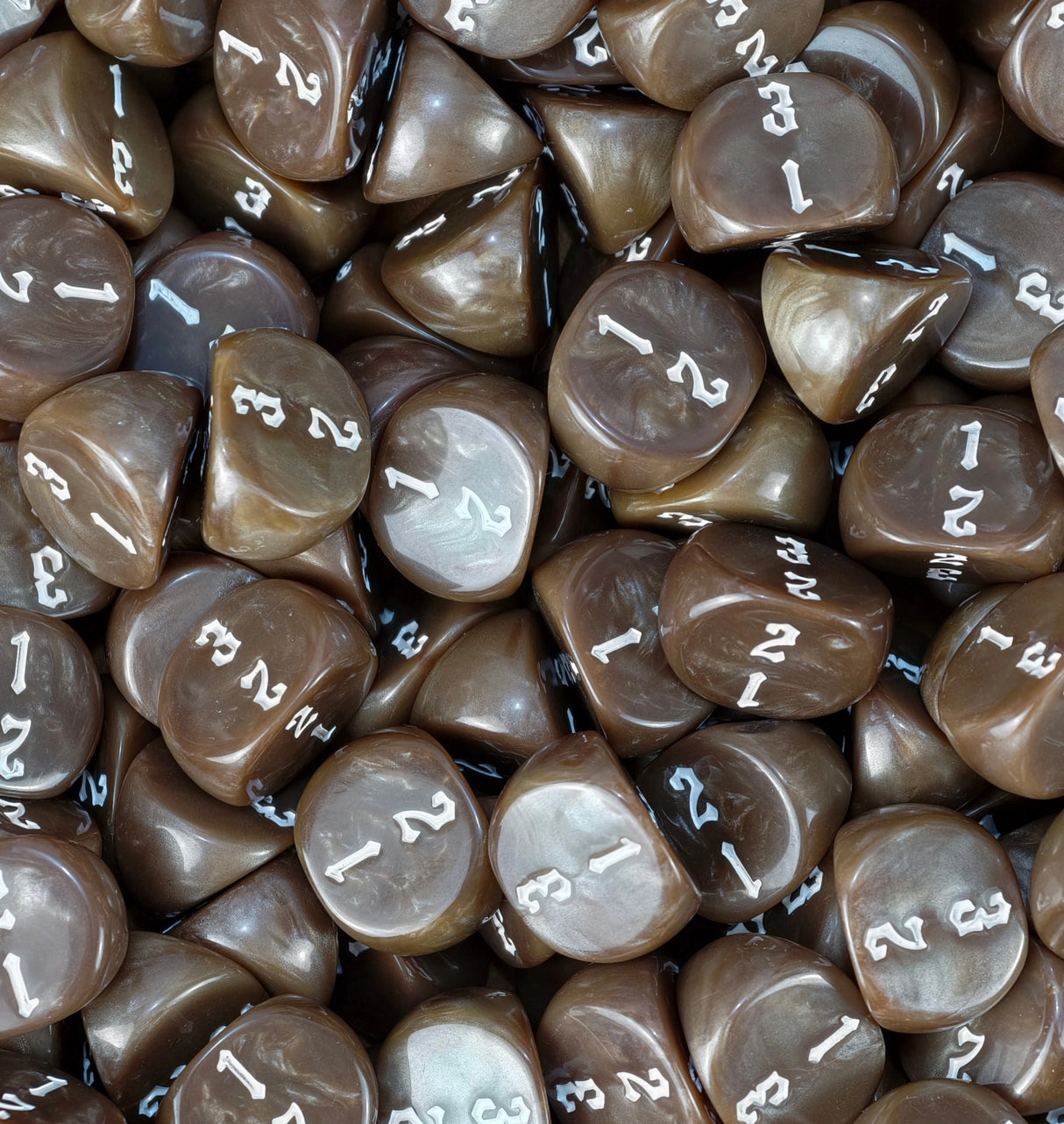 Brown D3 dice fill a tray, ready for a wargame or an RPG night