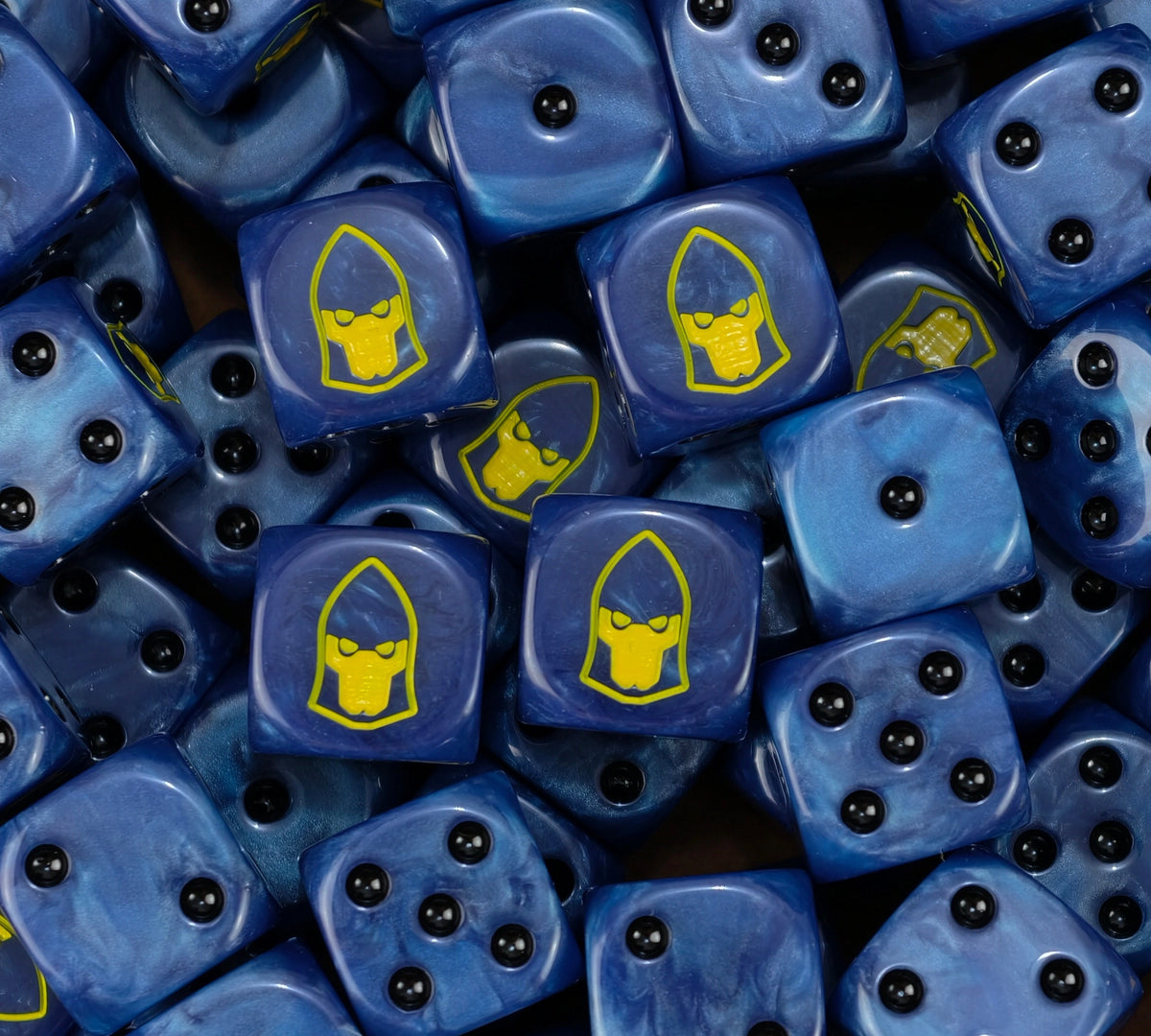 A pile of blue Alaitoc Eldar dice with yellow craftworld helms