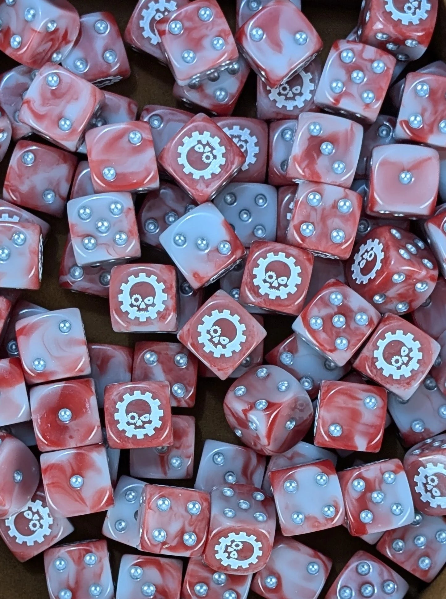 Pile of red and grey cog skull 16mm D6 dice for a sci-fi machine cult army