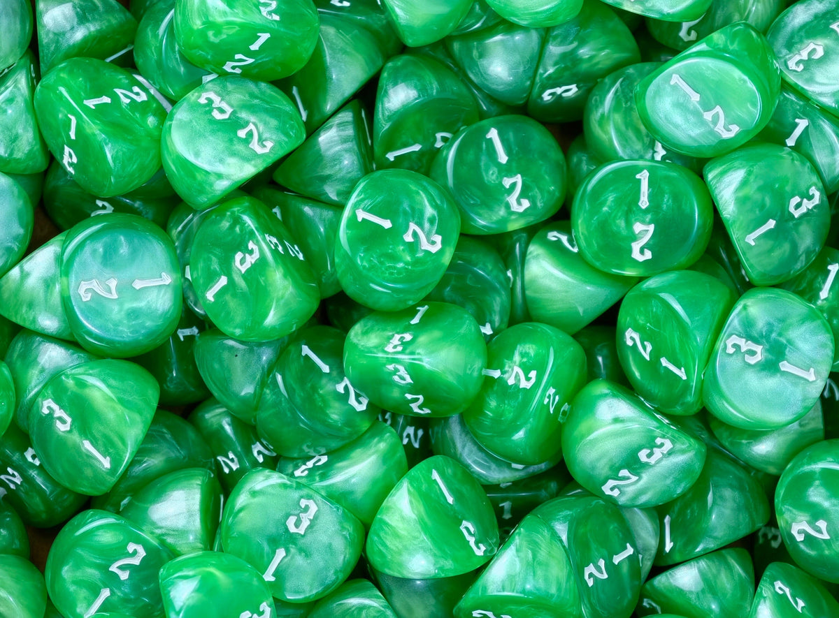 Emerald three sided dice spread wall to wall inside a dice tray