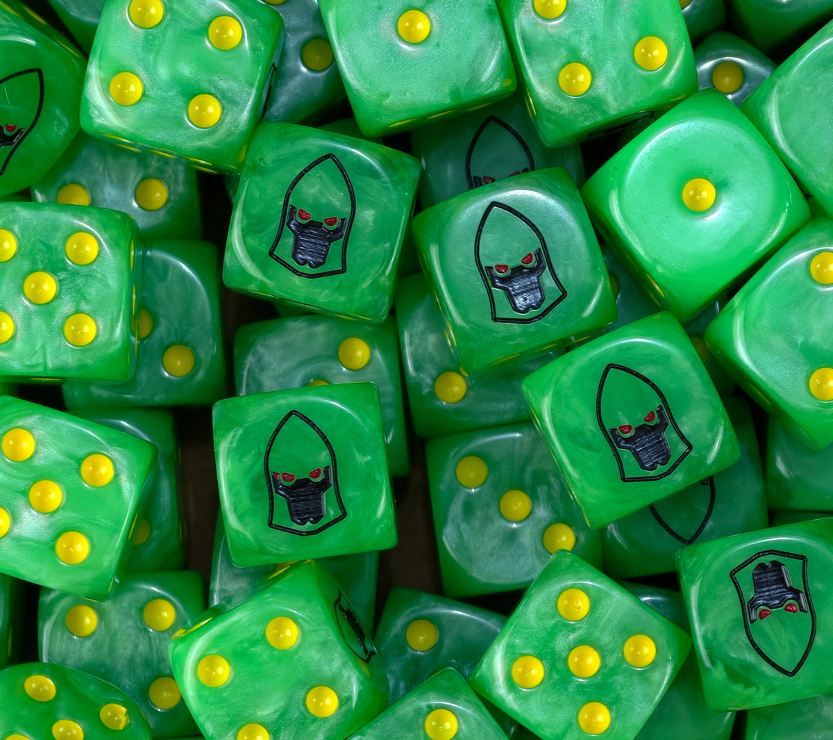 A pile of green Striking Scorpions dice with yellow pips and black helms