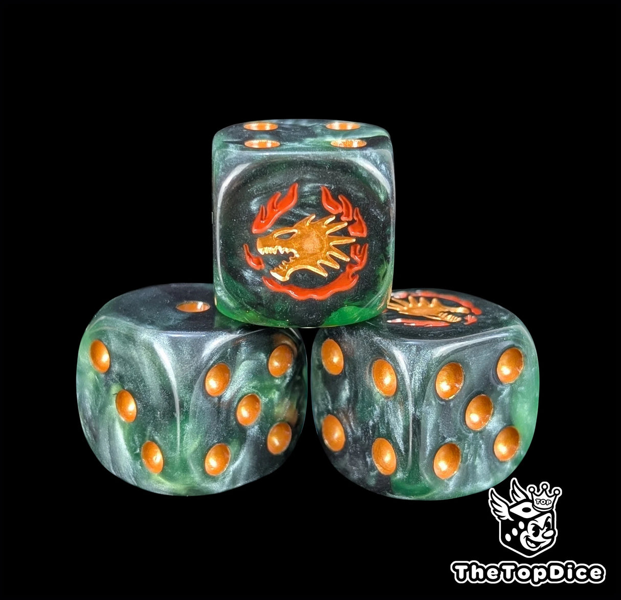 Close up of a green 16mm resin D6 die engraved with a gold drake face wreathed in orange flame
