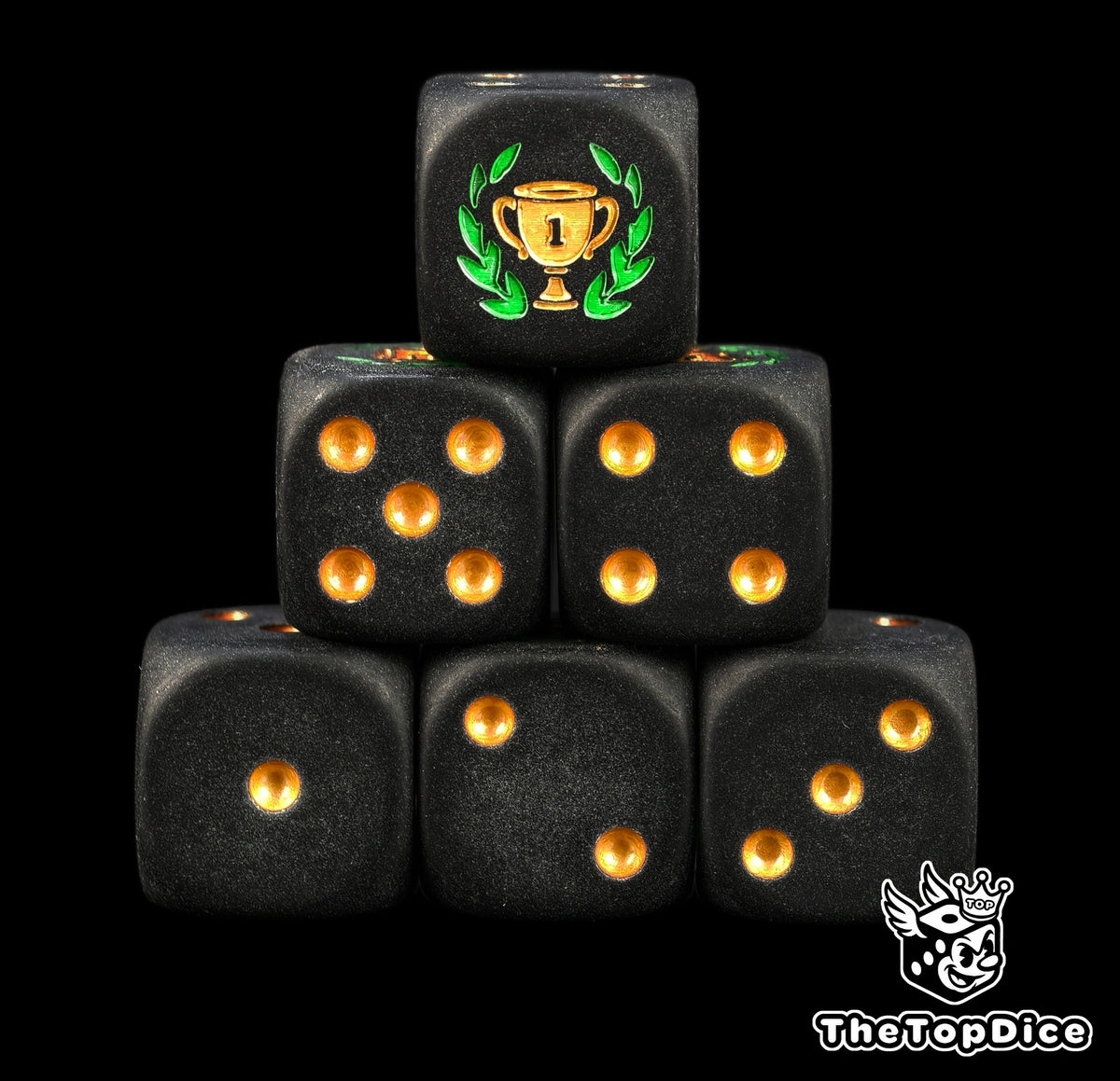 First place trophy dice, matte black 16mm D6 with gold pips and a gold winner's cup in a big green laurel, a tournament prize for board games and game nights