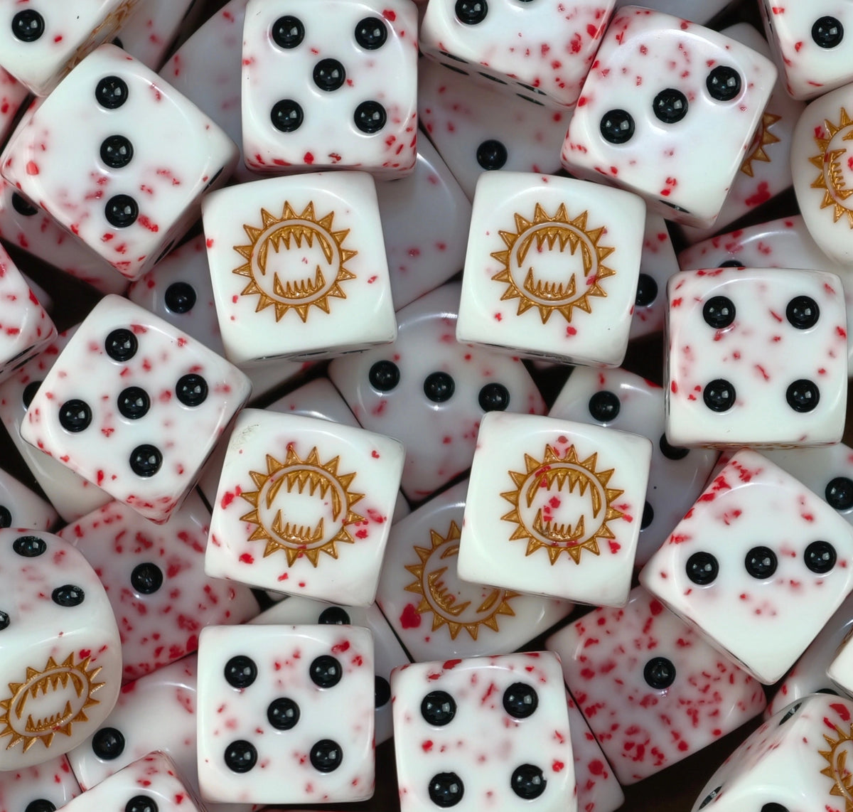 A pile of blood flecked World Eaters dice with a gold toothed maw