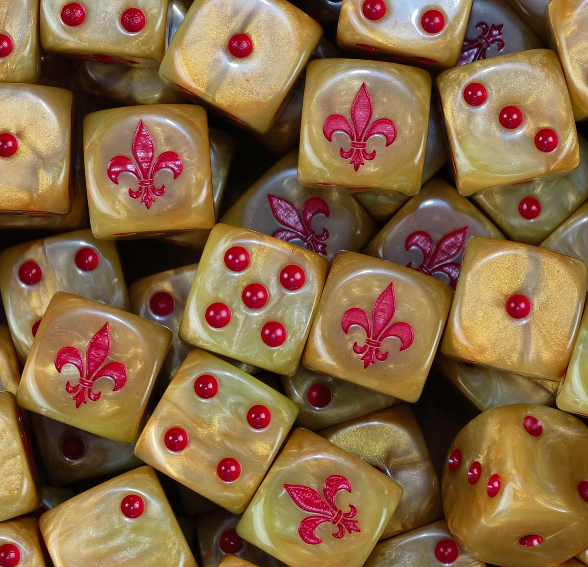 A pile of gold Sisters of Silence dice with red pips and red fleur de lis
