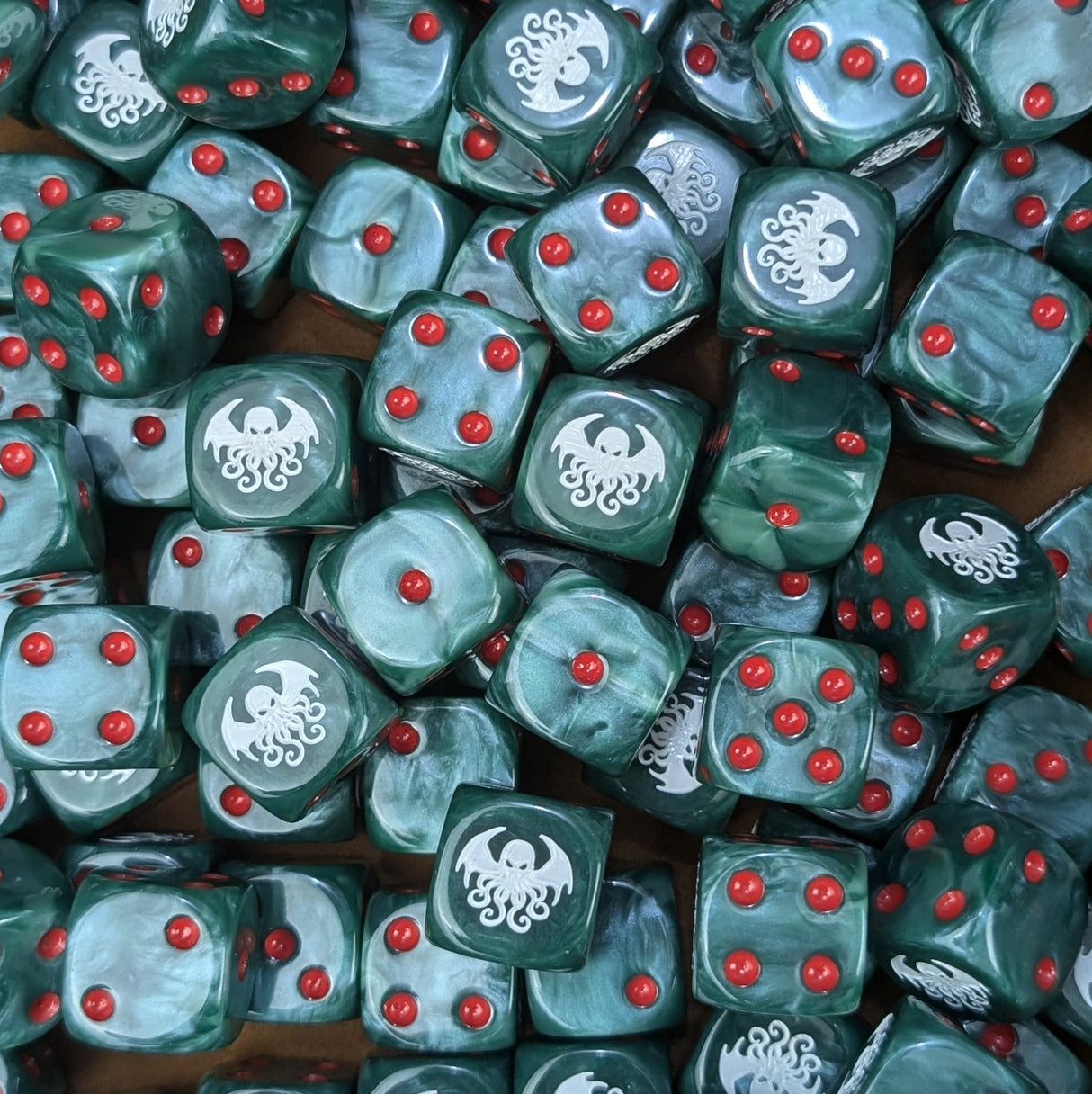Pile of green Cthulhu 16mm D6 dice for an RPG horror campaign