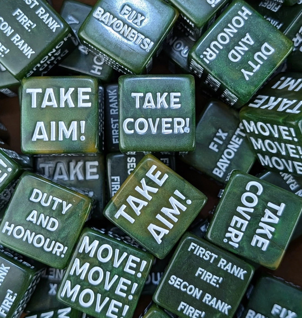 Pile of green 20mm command tokens beside a sci-fi guard army on the table