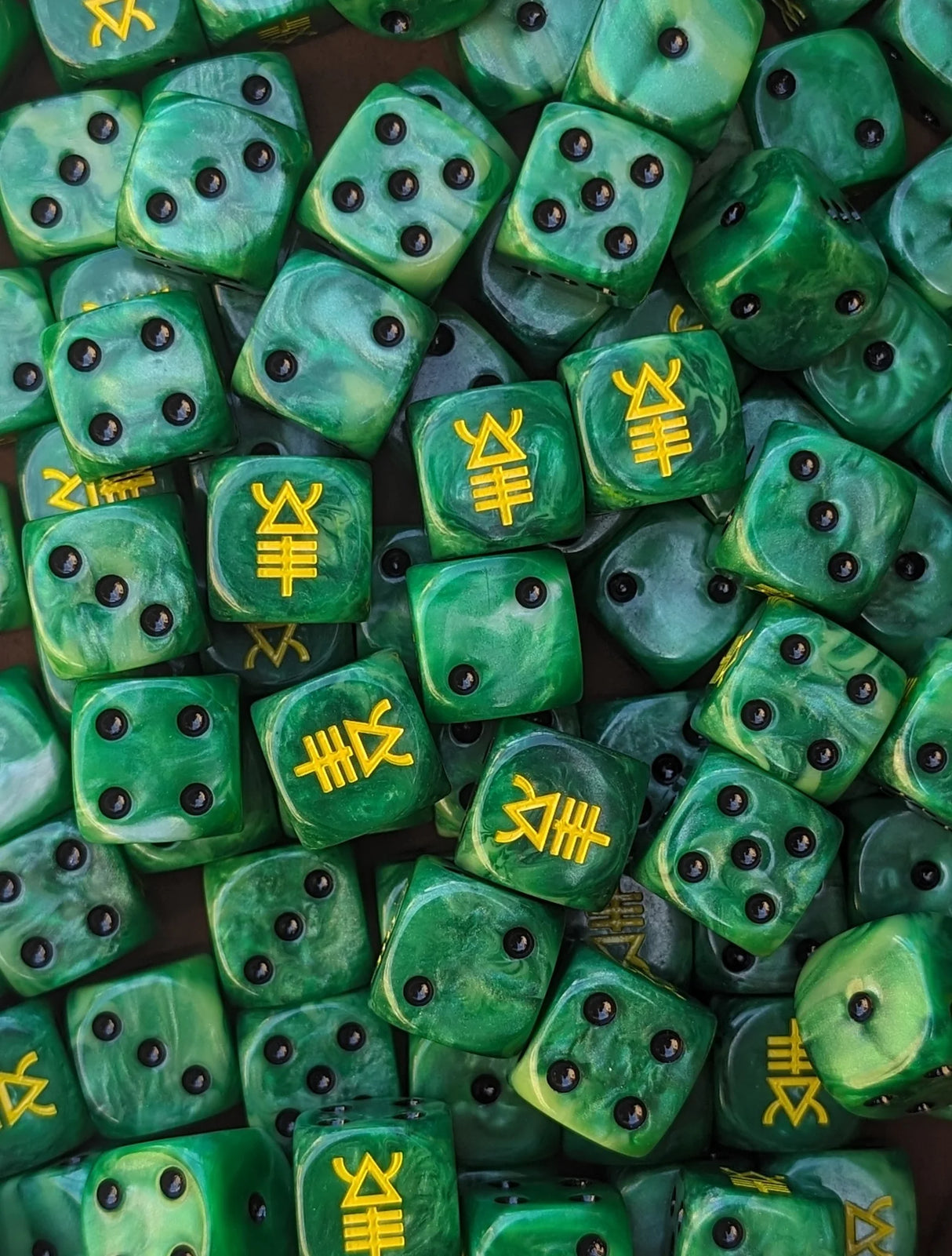 Pile of green scorpion 16mm D6 dice for a sci-fi alien army