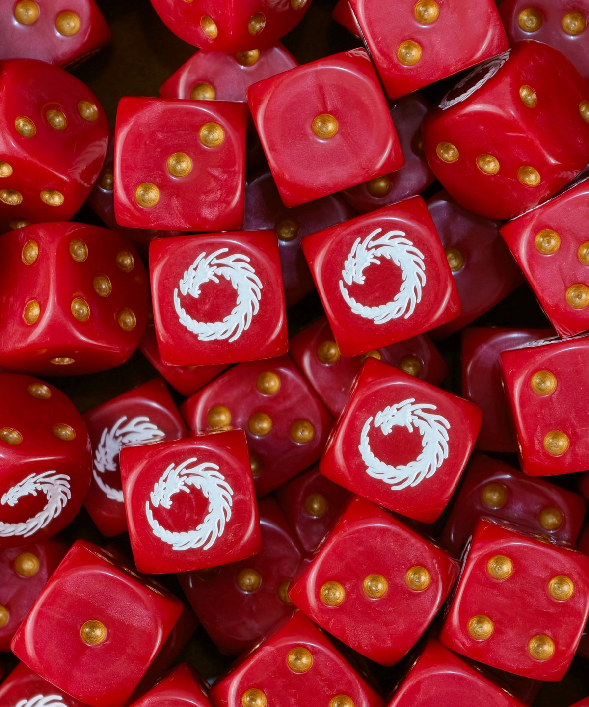 Pile of red XV Legion dice with gold pips and white coiled dragons