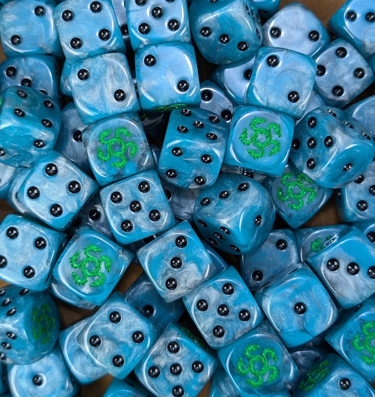 Custom teal and silver dice for Warhammer Alpha Legion forces