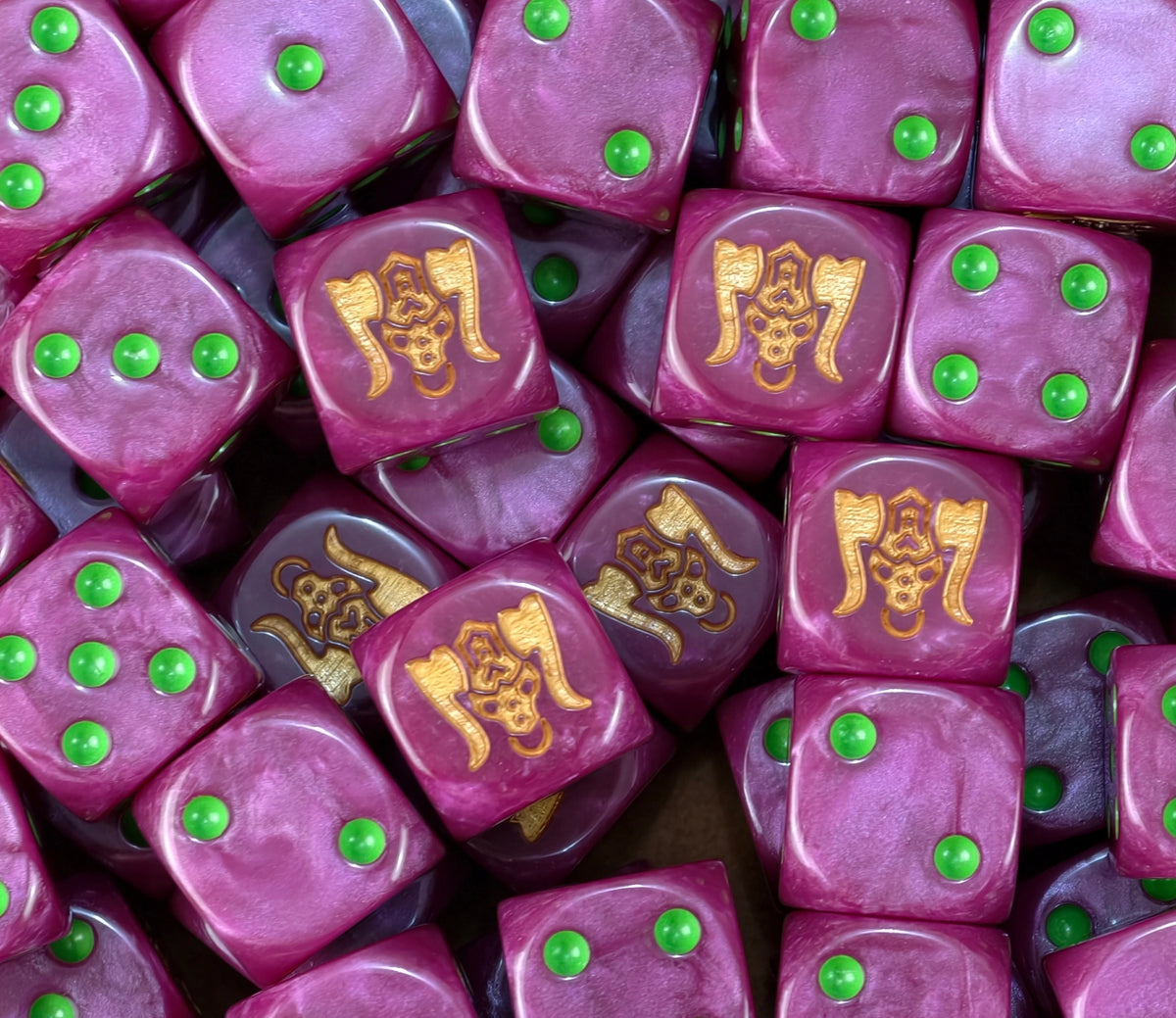 A pile of magenta chaos dwarf dice, gold bull heads and green pips repeating