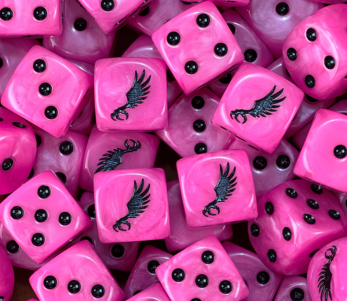 A pile of neon pink Slaanesh D6 with black pips and winged claws