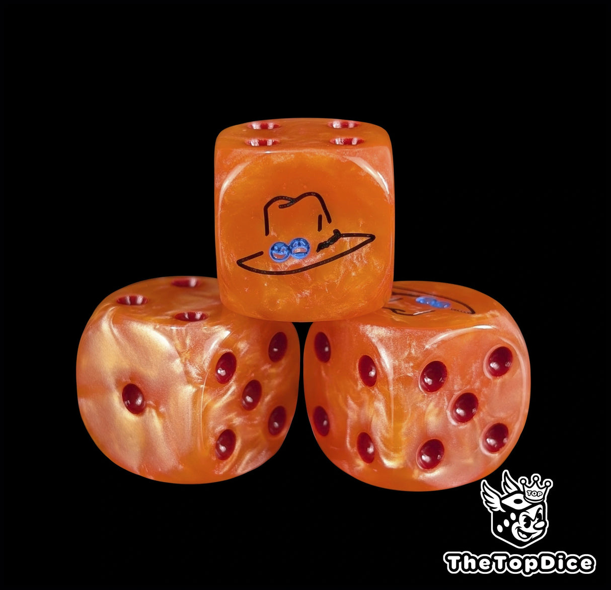 Close up of an orange 16mm resin D6 die engraved with a black flame hat emblem and red pips