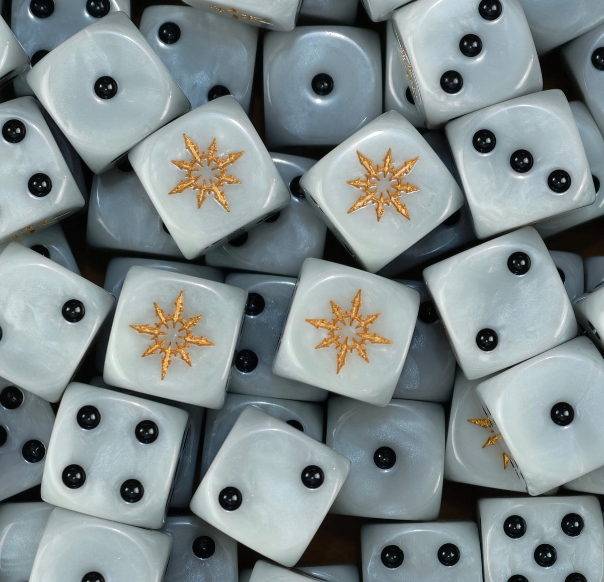 A pile of pearl white chaos D6 with black pips and gold stars