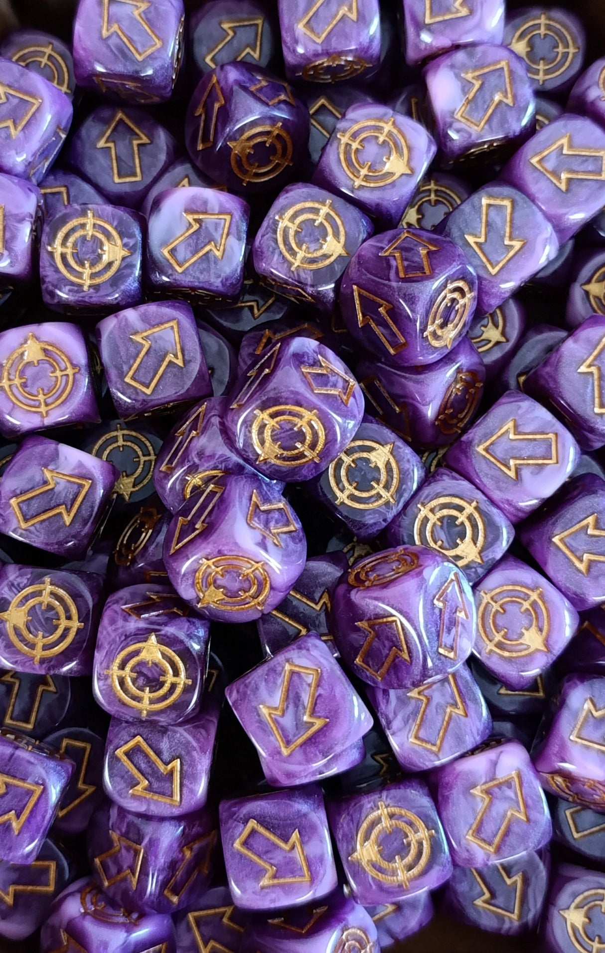 Pile of purple and pink scatter dice for tabletop battles