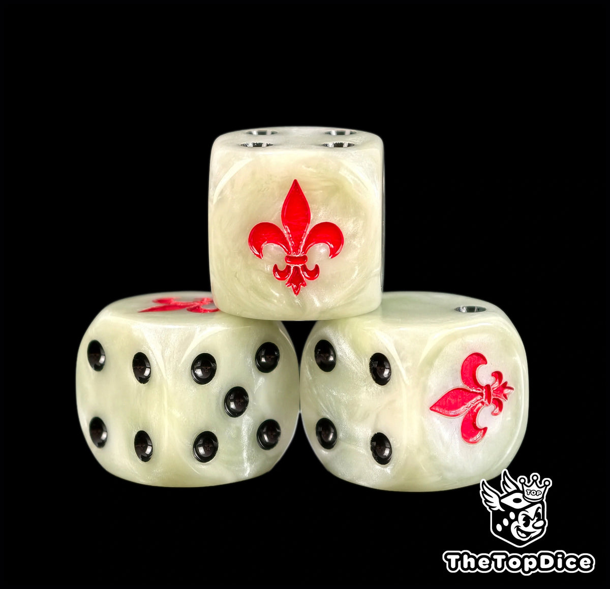 Three bone white Battle Sisters dice with a red fleur de lis