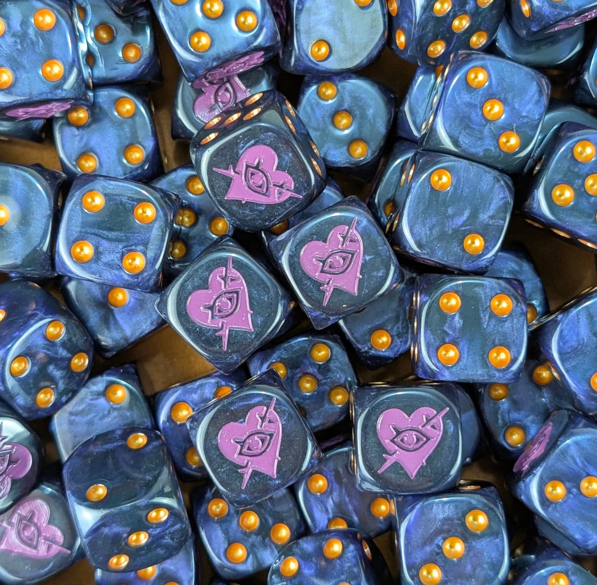 Pile of black and purple barbed heart 16mm D6 dice for a sci-fi raider army