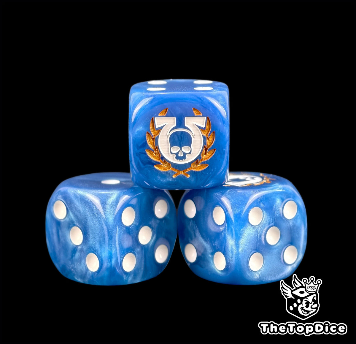 Three blue Ultramarines dice with an omega skull in a gold laurel