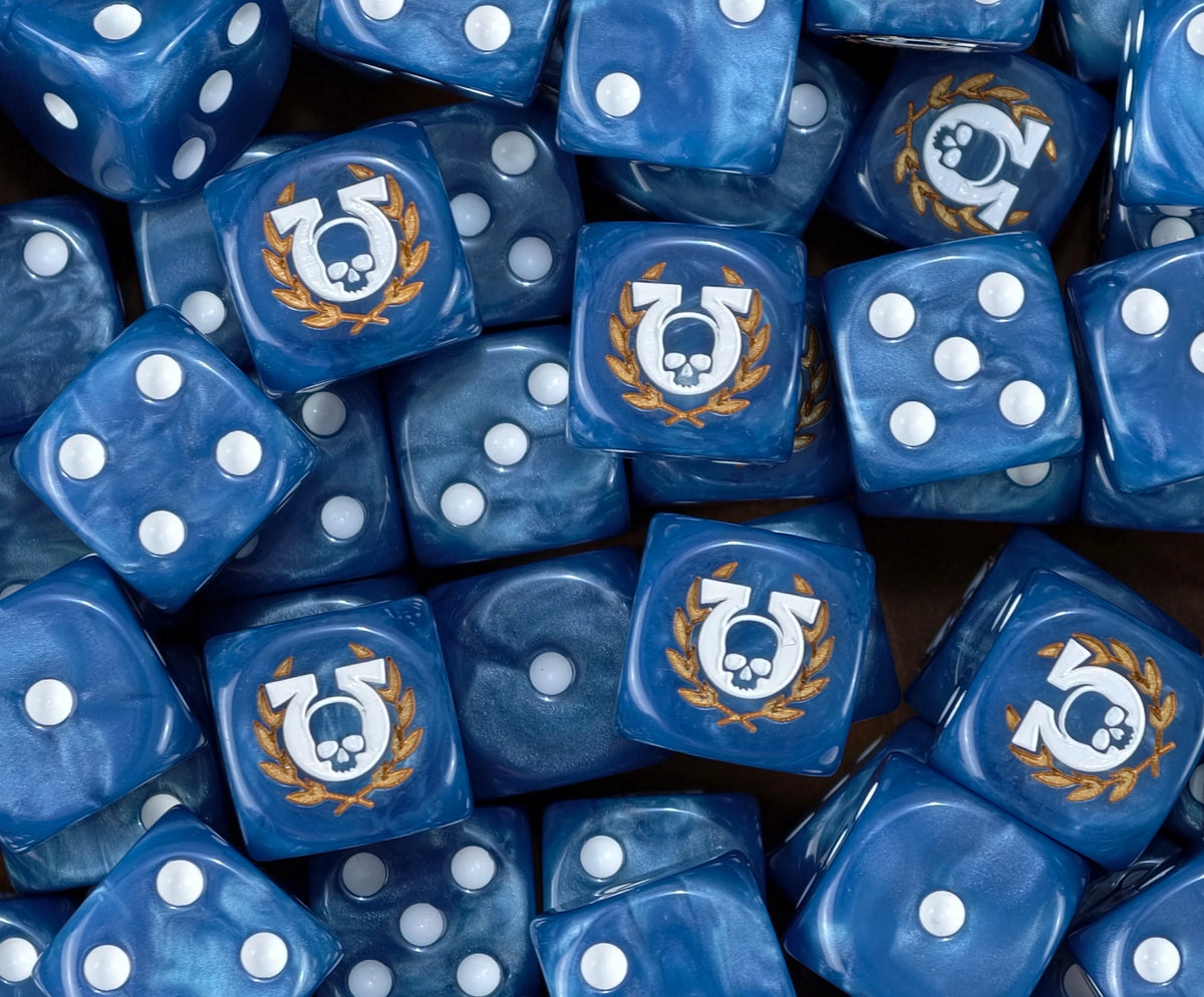 A pile of blue Ultramarines D6 with omega skulls in gold laurels
