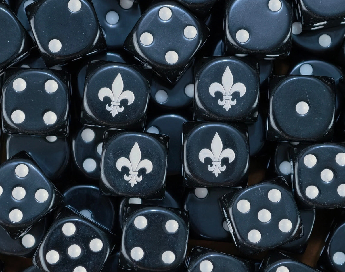 A pile of black Adepta Sororitas dice with white pips and fleur de lis