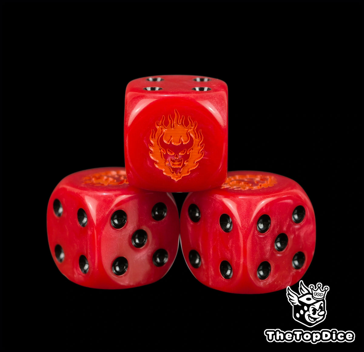 Close up of the orange fire daemon face engraved and hand filled on a crimson Word Bearers 16mm D6 die
