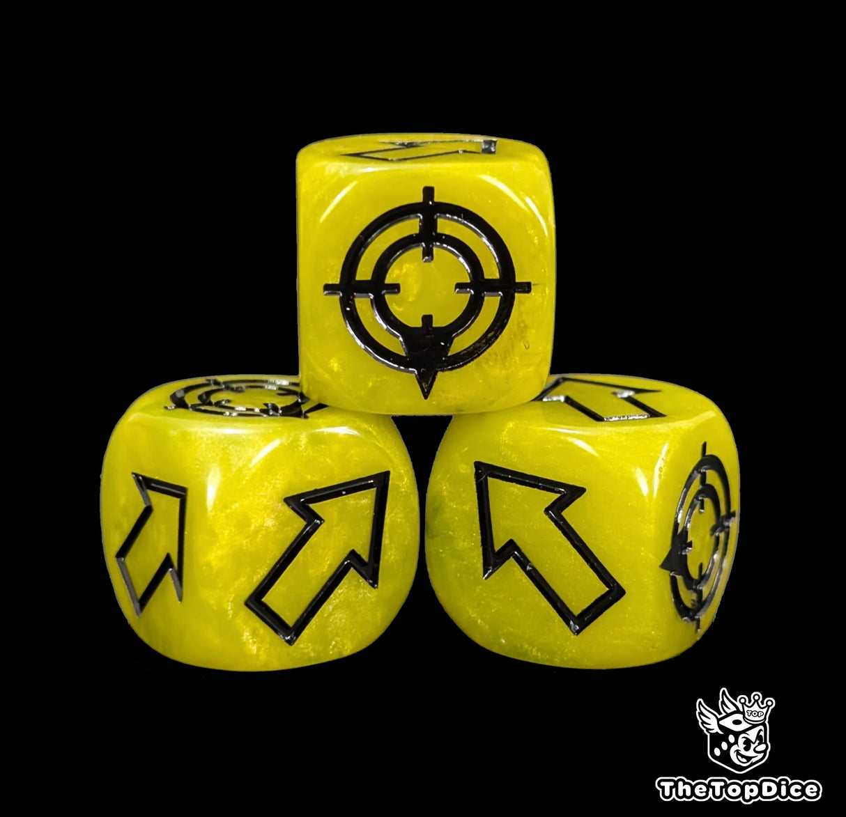 Close up of a yellow resin scatter die showing the black direction arrows