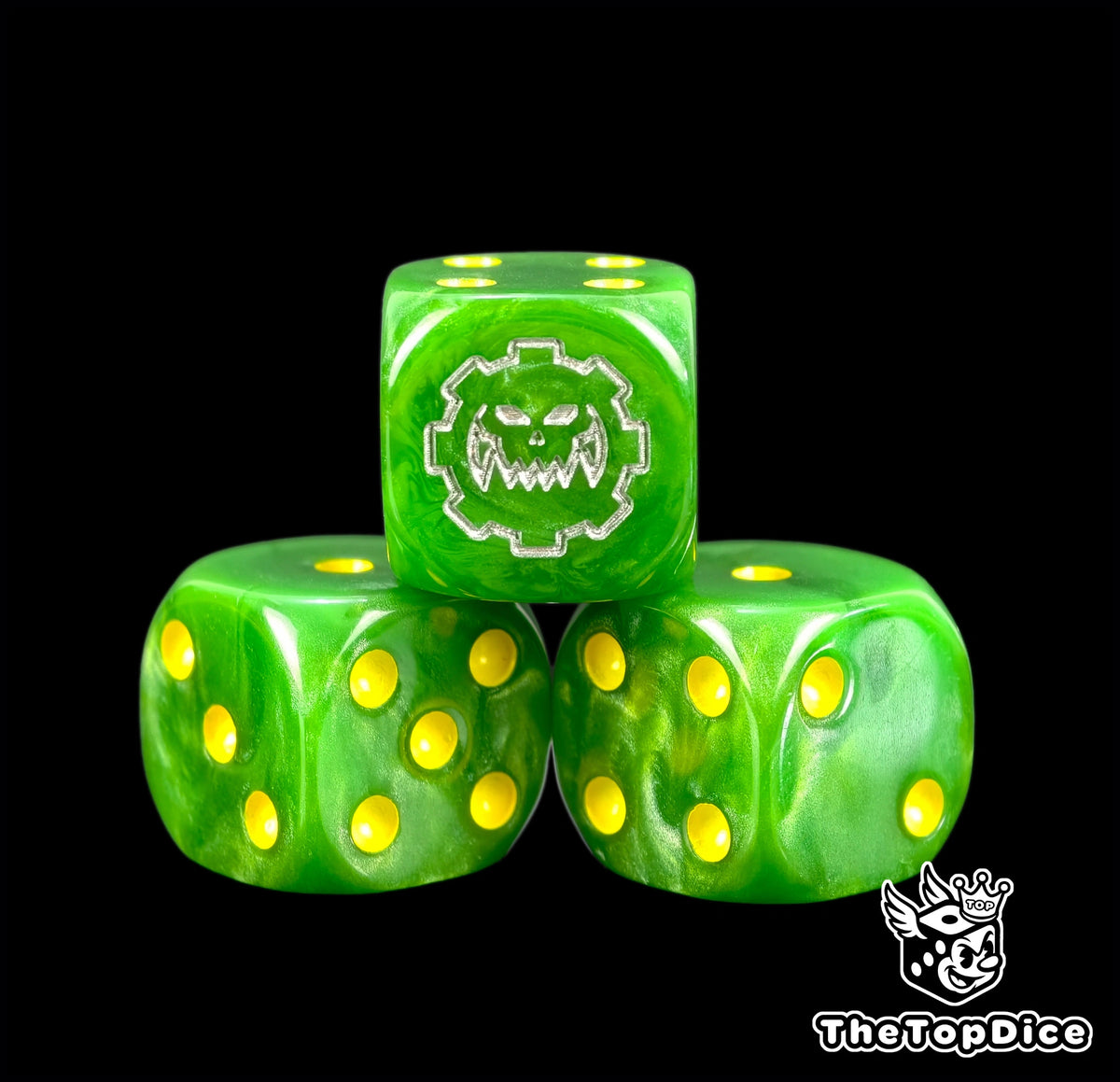 Three green greenskin orc dice with yellow pips and a silver gear skull
