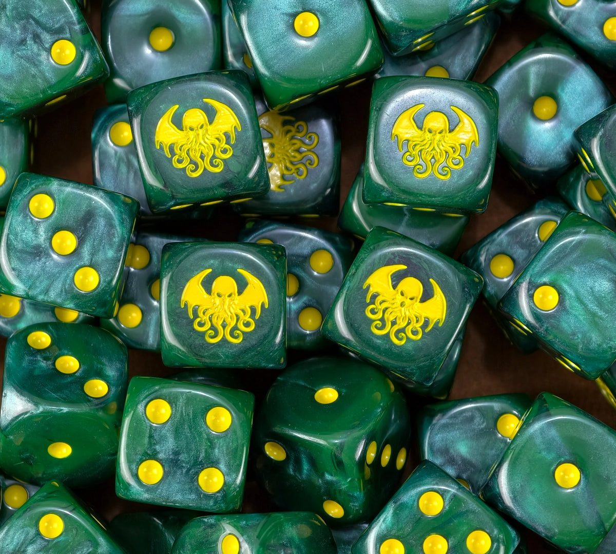 A pile of green Cthulhu D6 with yellow pips and tentacled heads