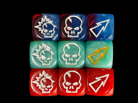 Nine 16mm resin block dice in three team colours showing the skull, the skull and burst and the arrow faces