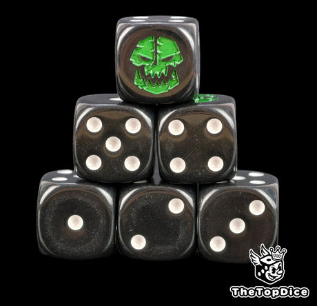 Six black 16mm D6 with white pips and a green orc face with tusks on the six