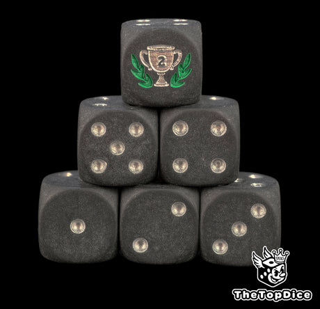 Six matte black 16mm D6 with silver pips and a silver trophy cup in a green laurel on the six