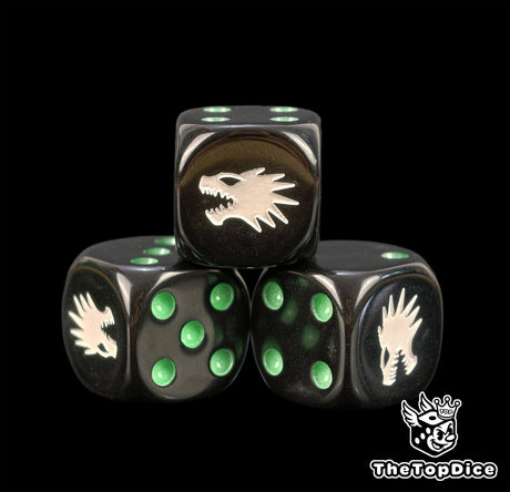 Close up of black Vulkan Salamanders dice with green pips and a white drake profile