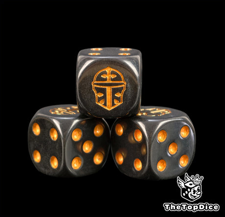 Close view of the gold knight helm engraved on a black D6 for Adeptus Titanicus games