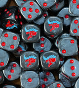 A pile of black Tyranid dice, red alien heads with blue crests and red pips repeating
