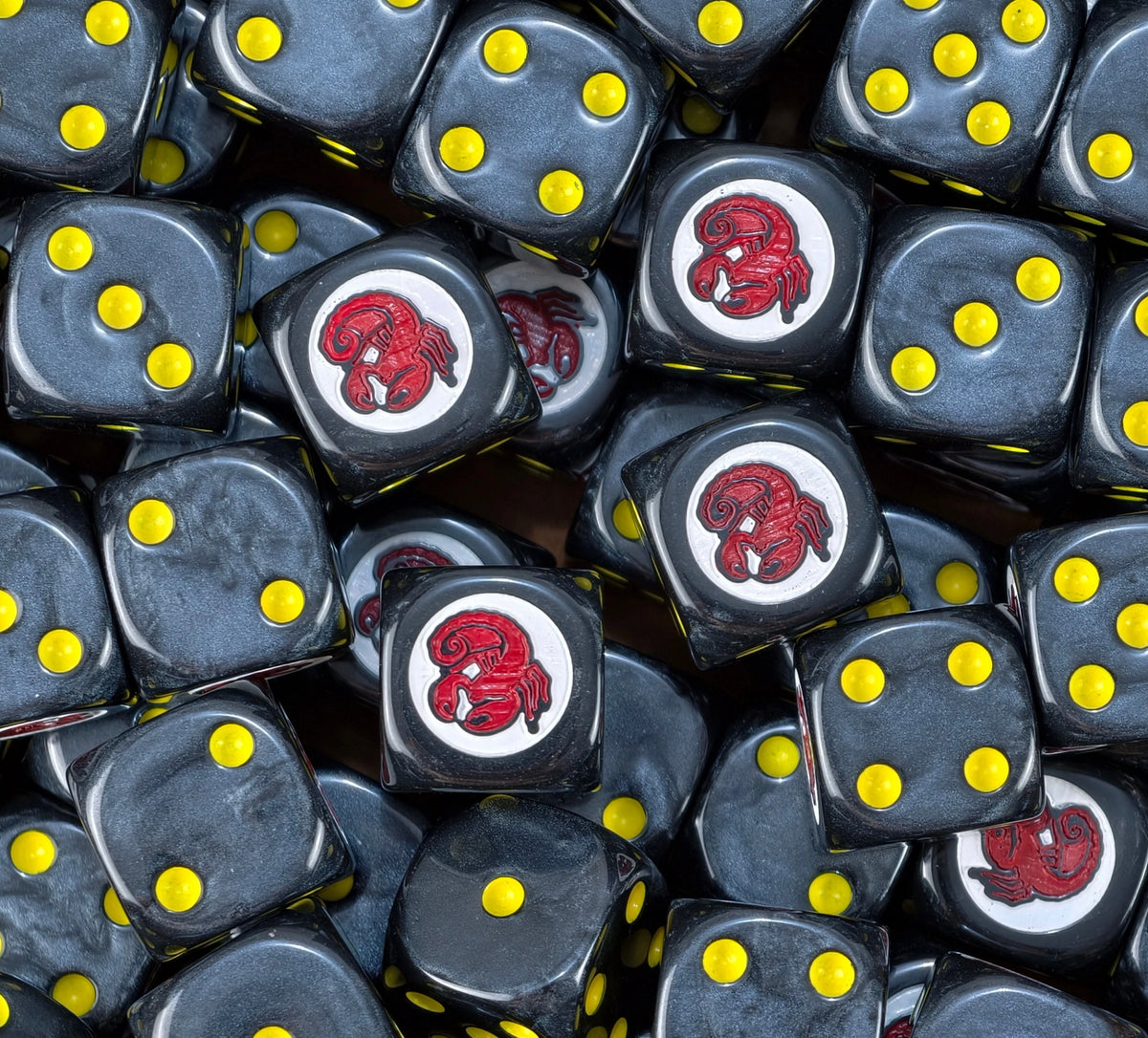 A pile of black Red Scorpions dice, red scorpion badges and yellow pips repeating