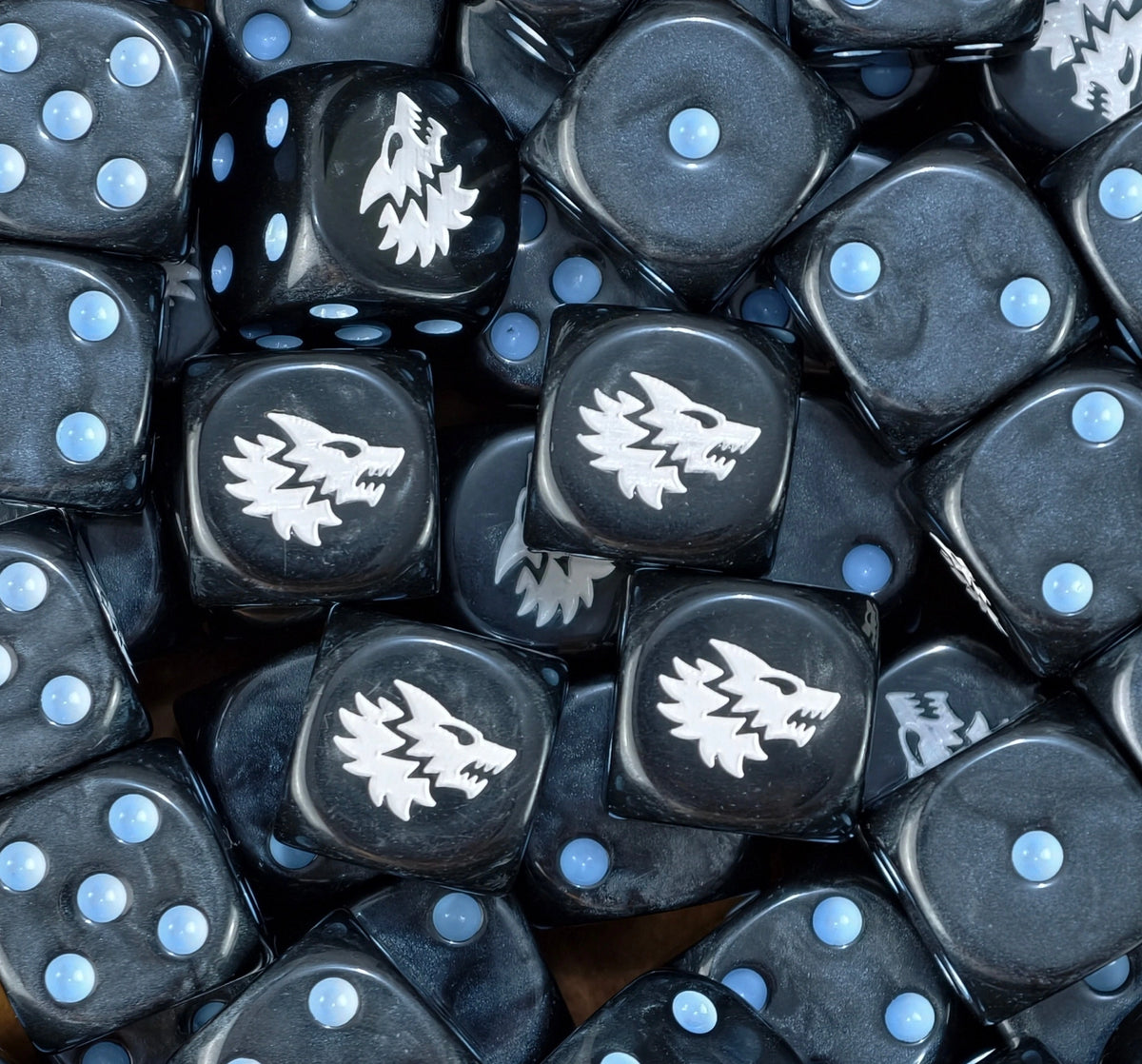 A pile of black Space Wolves dice, white wolf heads and sky blue pips repeating