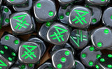 A pile of black Skaven dice, green runes and green pips repeating