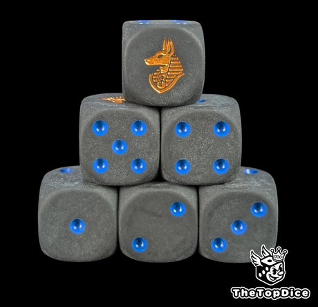 Black 16mm D6 dice with a gold anubis jackal emblem and blue pips for fantasy and DnD