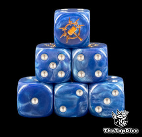 Six blue Stormcast D6 stacked, silver pips and a gold storm hammer