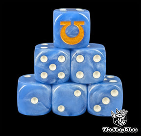 Blue resin D6 dice with a gold sigil emblem and white pips