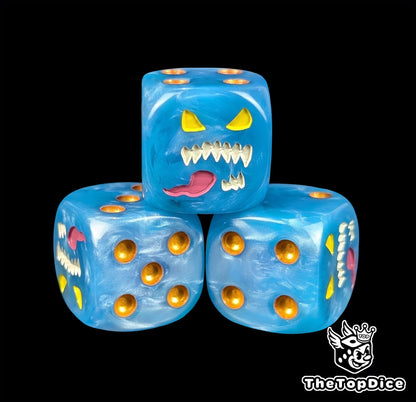 Close up of a blue 16mm resin D6 die engraved with a blue daemon face, yellow eyes and gold pips