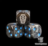 Close up of three blue Necron dice, black grey marbled resin with a silver dynasty glyph and blue pips